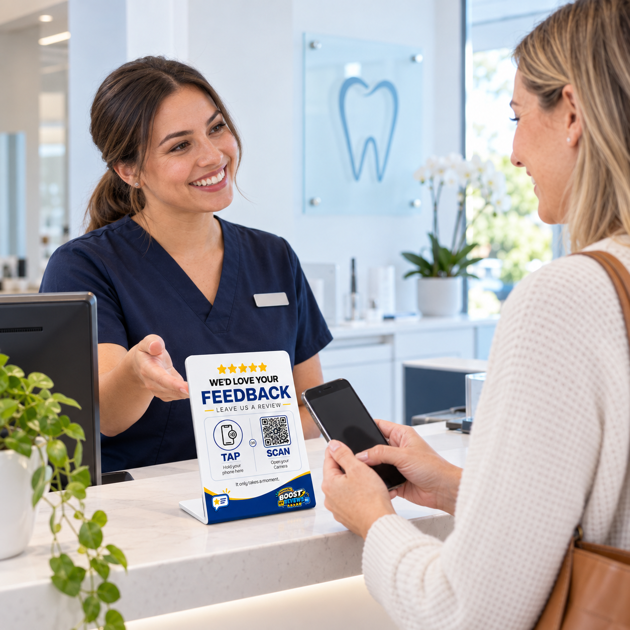 Dental patient holding a smartphone near a Boost My Reviews counter stand at reception.